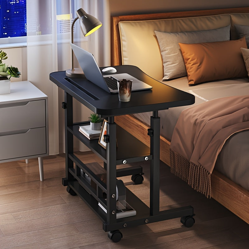 Black height-adjustable mobile laptop desk with storage shelves beside a bed