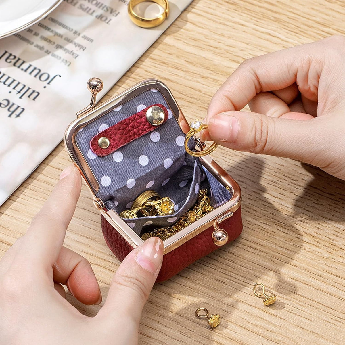 Case held open with rings being placed inside the polka dot lining