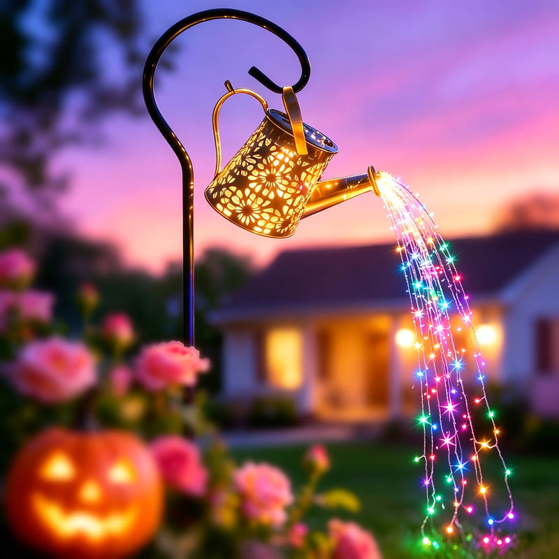 Color changing watering can light pouring multicolor strands over roses at dusk
