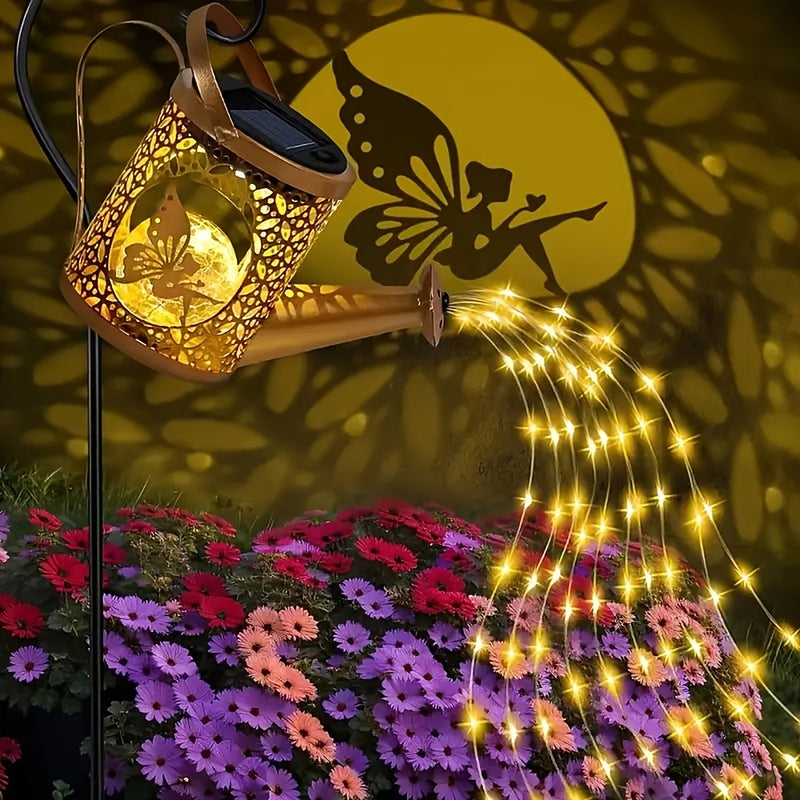 Solar watering can light with warm fairy lights cascading from the spout