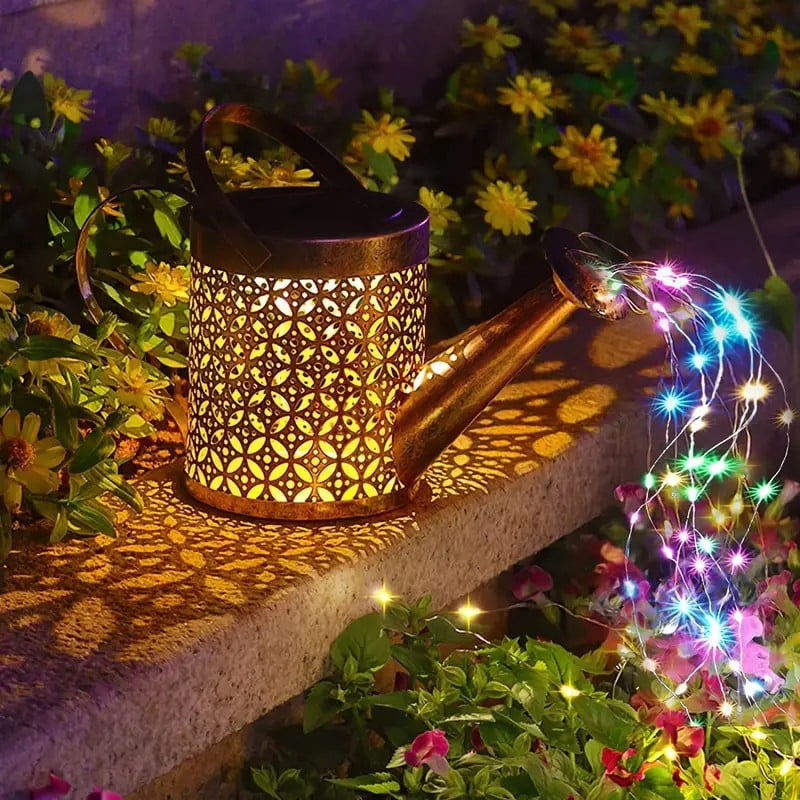 Multicolor watering can light on a stone step with the cutout pattern lit