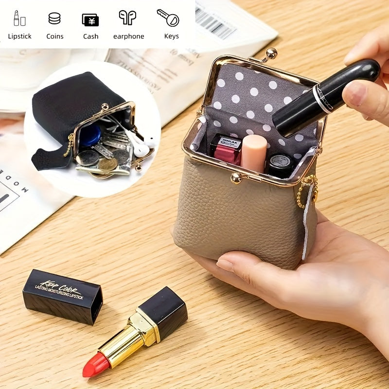 Taupe purse held open with a lipstick being placed inside