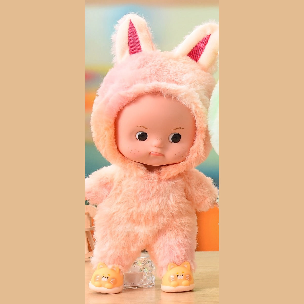 Pink plush onesie doll with eyes open, standing