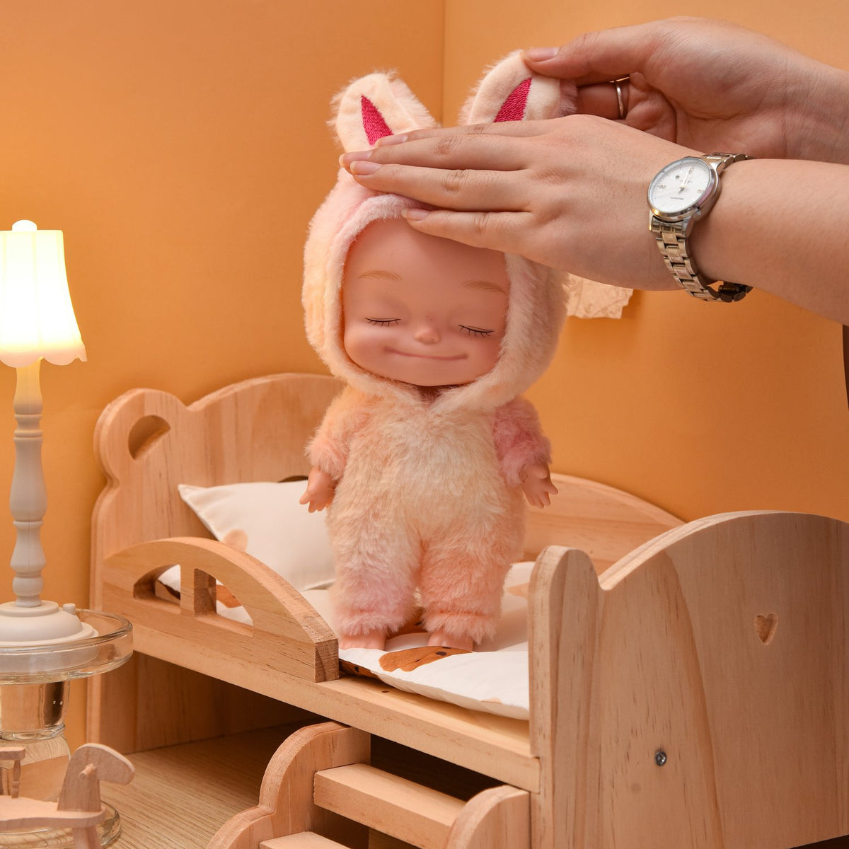 Eyes closed doll held in a hand to show its size