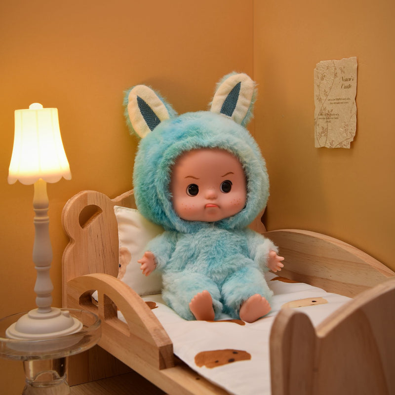 Eyes open doll seated in a wooden toy bed
