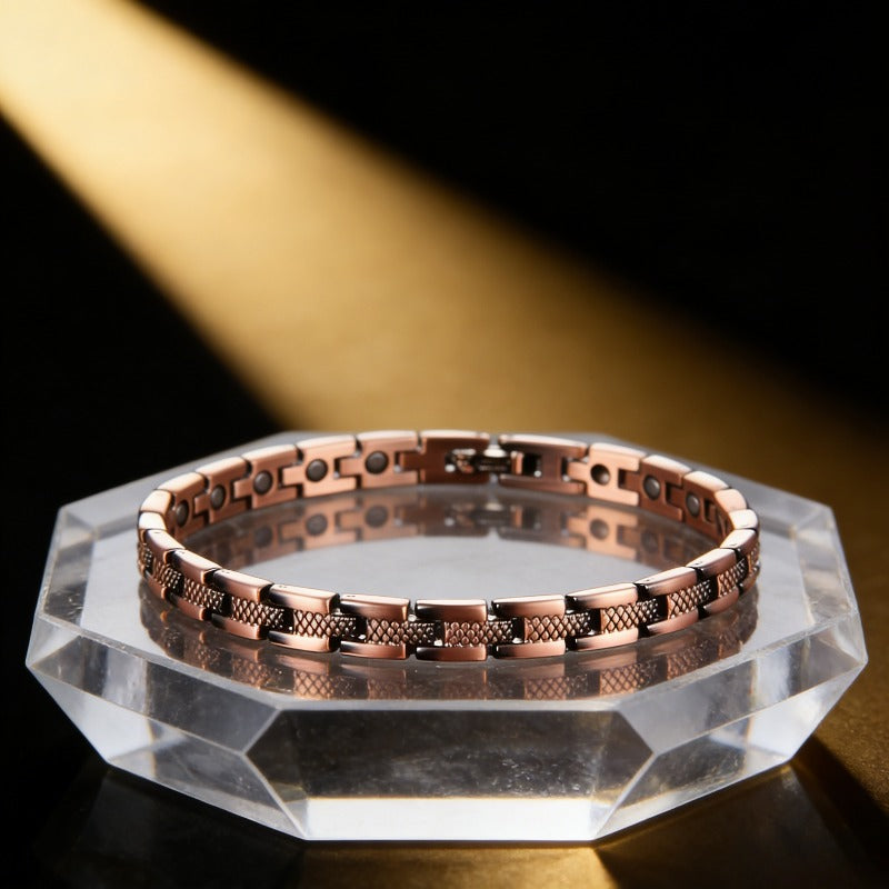 Copper-tone magnetic link bracelet on a display stand