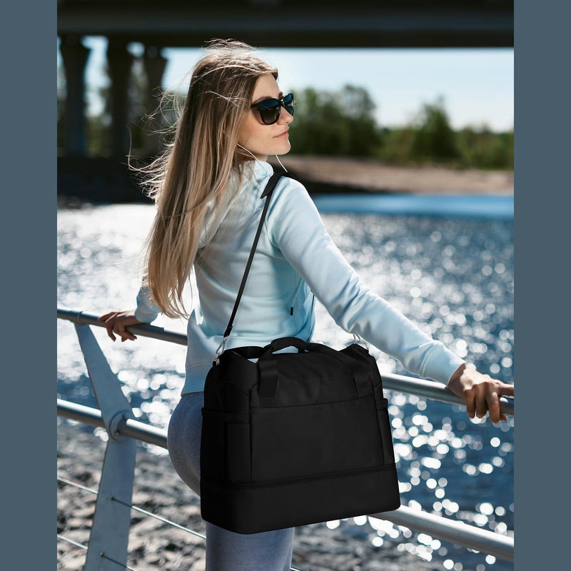 Woman carrying the black duffel by its shoulder strap beside a waterfront railing