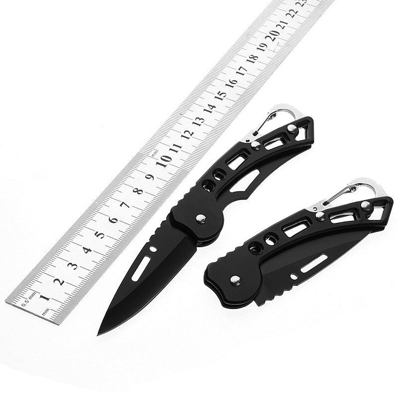 Pocket knife beside a ruler showing its size open and closed