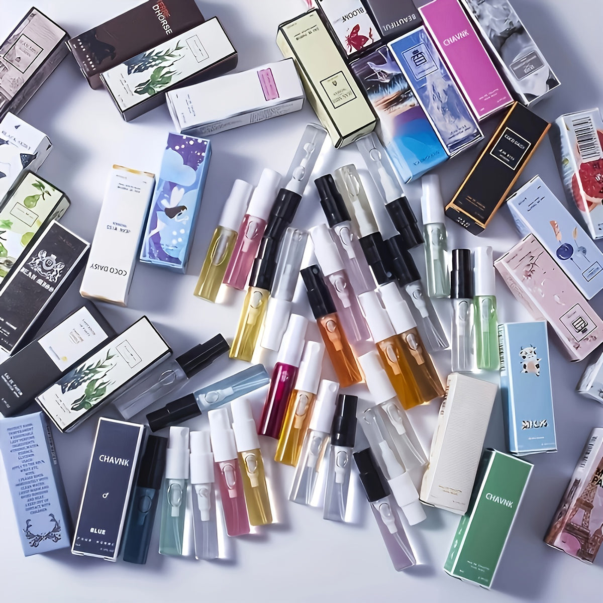 Assorted mini perfume spray vials and their boxes