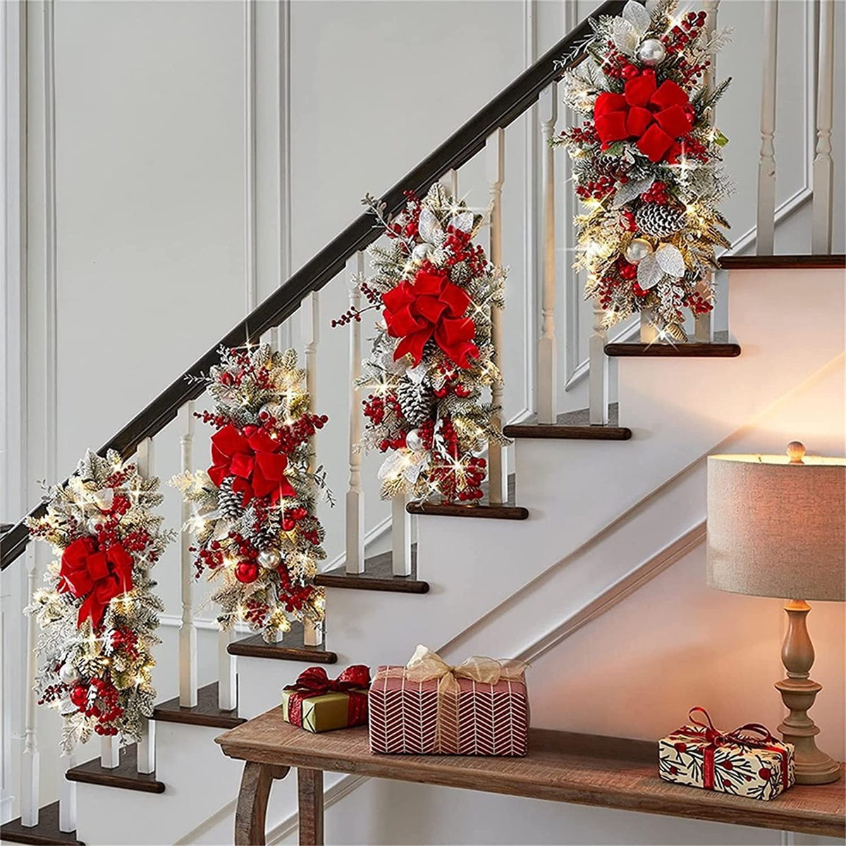 Four lit swags hung in a row down a staircase banister