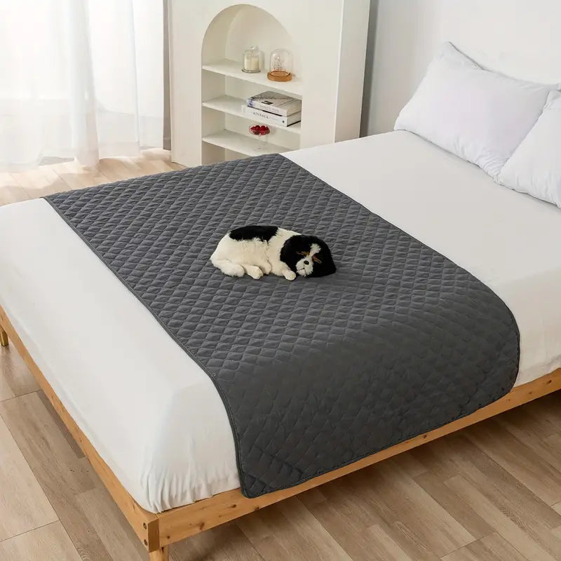 Waterproof Pet Bed Cover for Furniture in dark gray, laid down over a queen size bed