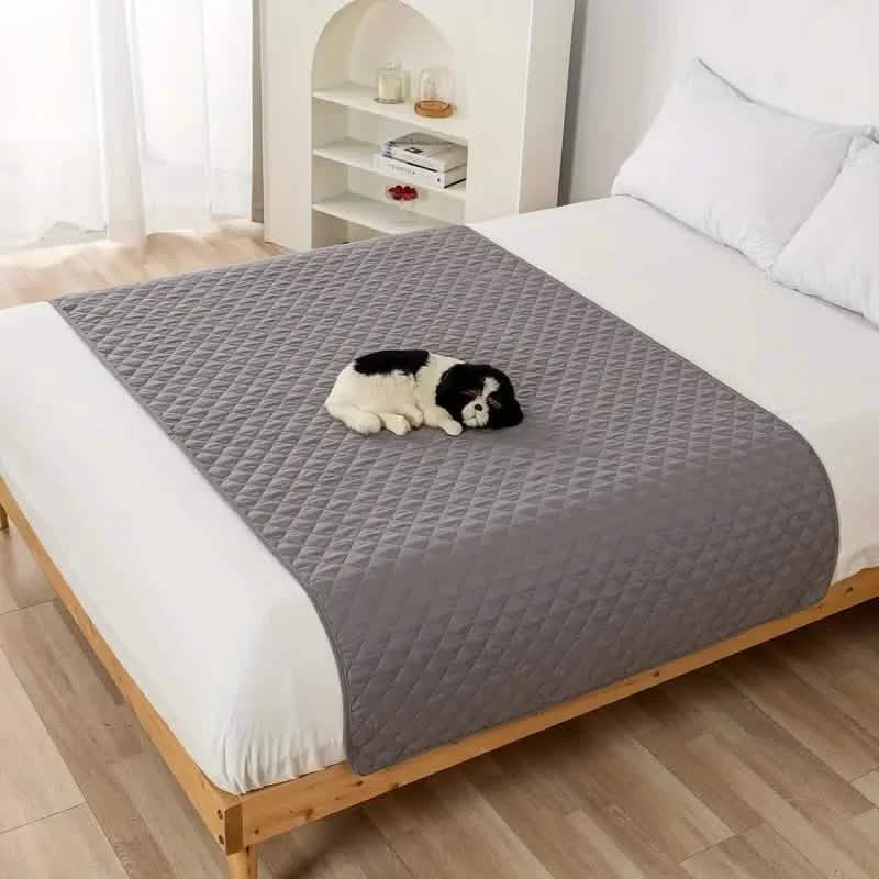Waterproof Pet Bed Cover for Furniture in light gray, laid down over a queen size bed