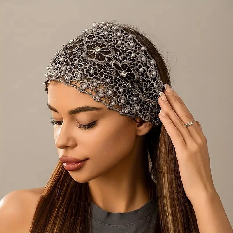 The grey crochet lace headband worn pushed back over the hair