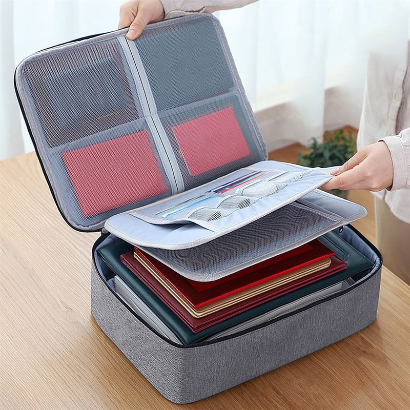 Gray document organizer box open, showing four mesh lid pockets, the removable zip panel and a full stack of documents