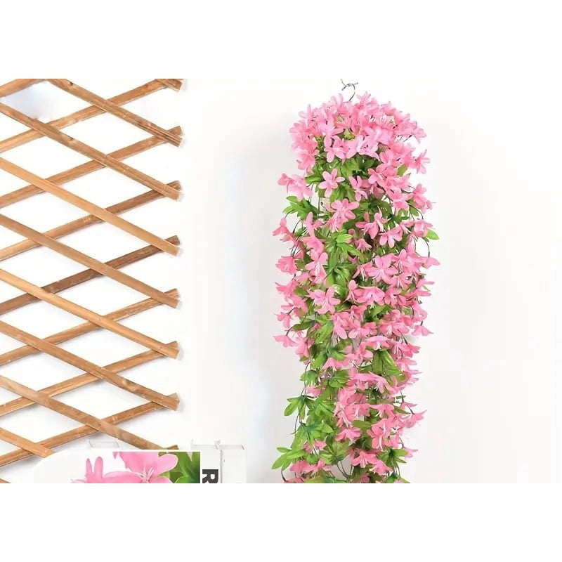 Pink artificial lily vine hanging on a wooden trellis