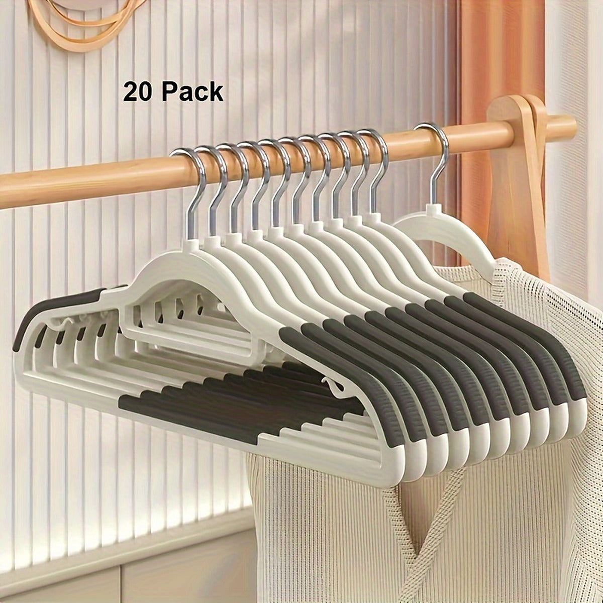 Twenty ivory hangers with dark gray ribbed shoulder grips on a closet rail, labeled 20 Pack