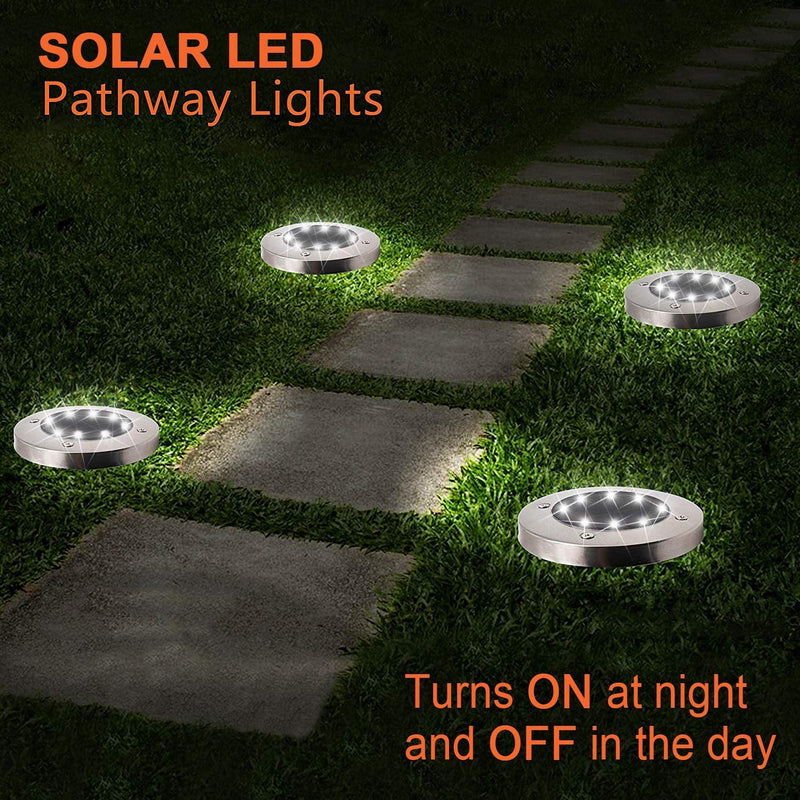 The disk lights lit along a stone pathway at night