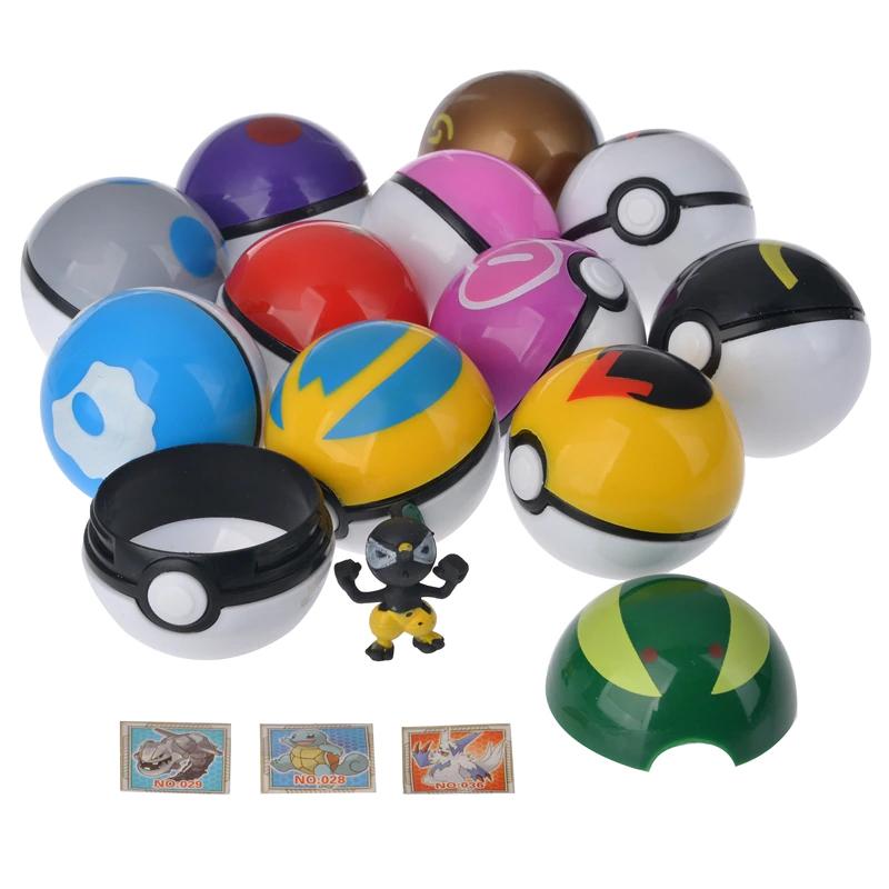 12 different Poke balls in a pile, 1 open Poke Ball in the front, figurine standing with arms up, 3 small cards at the bottom