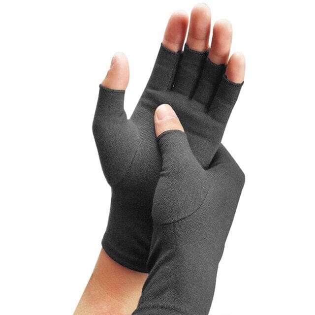 Woman wearing a pair of Rheumatoid Arthritis Magnetic Compression Gloves while pressing with a thumb on the palm of the other hand