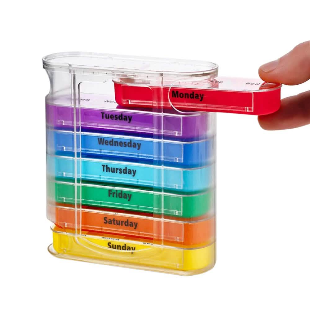 Closeup of a hand pulling out a pill box out or a 7 Day Stackable Pill Box Dispenser
