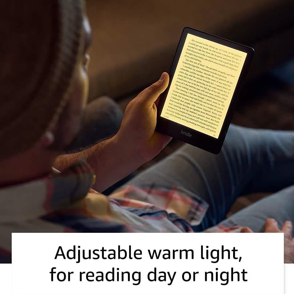 Man sitting down holding an Amazon Kindle Paperwhite 11th Generation while reading an eBook