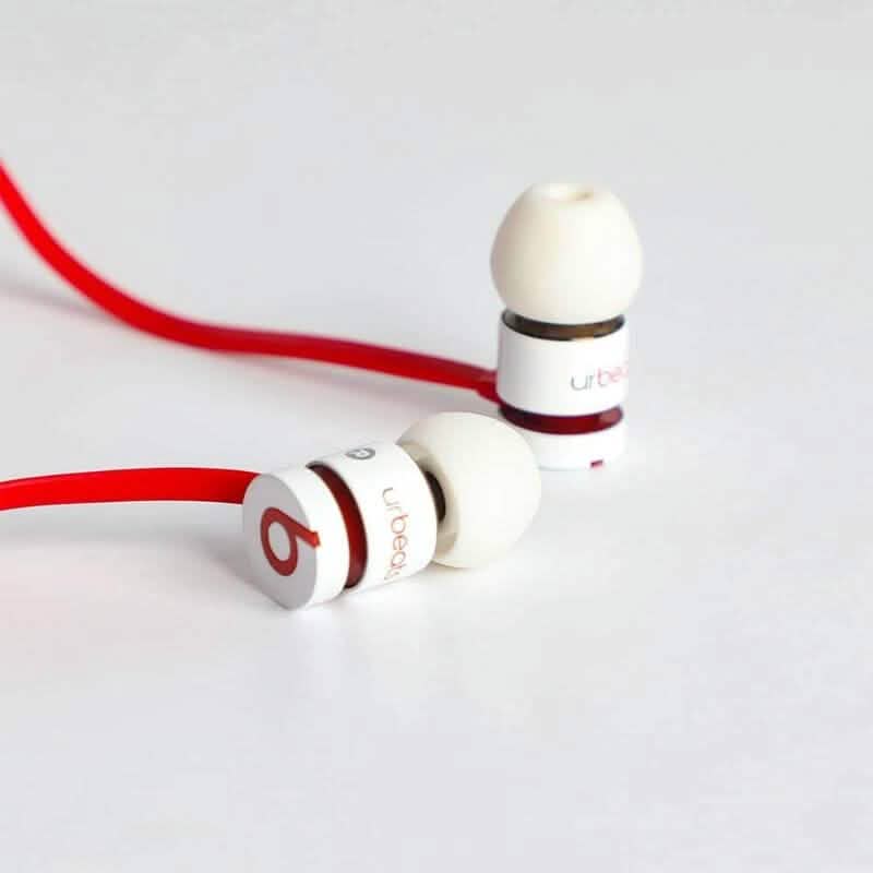 View of pair of Beats by Dr. Dre UrBeats Earphones – 3.5mm Connectors in white on a white surfacce