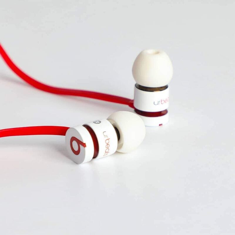 View of pair of Beats by Dr. Dre UrBeats Earphones – 3.5mm Connectors in white on a white surfacce