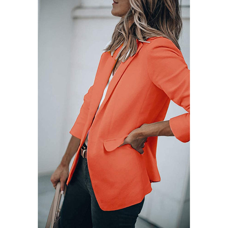 Woman standing on her side with a hand in the pocket wearing a Cicy Bell Womens Casual Blazer, shown in orange