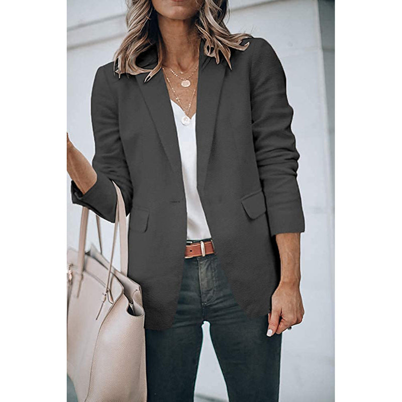 Woman holding her purse in the crook of her arm wearing a Cicy Bell Womens Casual Blazer, shown in gray