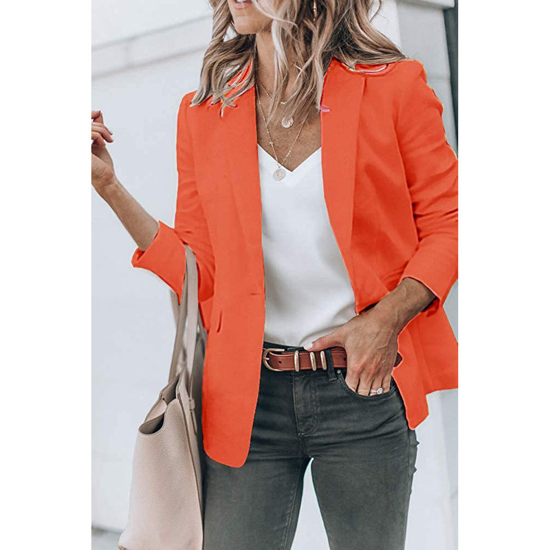 Woman with a hand in her jeans' pocket wearing a Cicy Bell Womens Casual Blazer, shown in orange