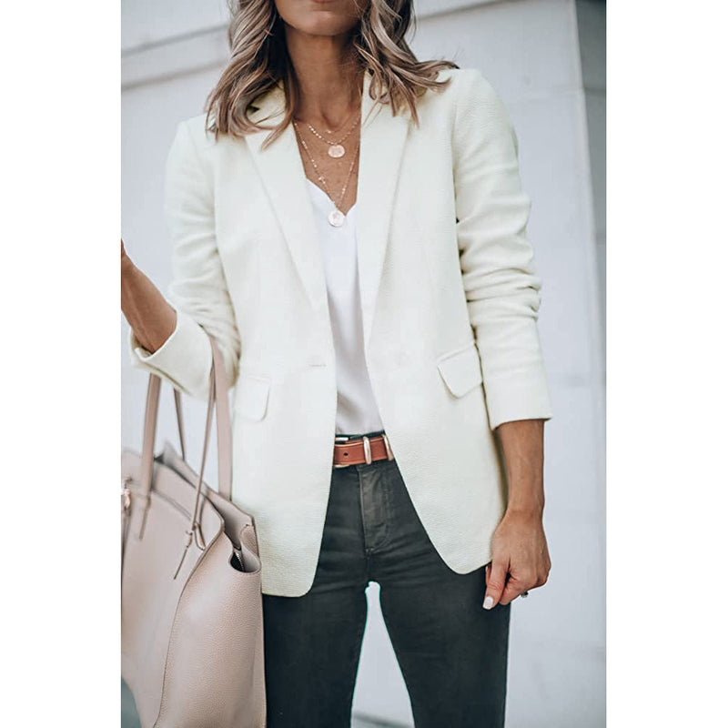 Woman holding her purse in the crook of her arm wearing a Cicy Bell Womens Casual Blazer, shown in white