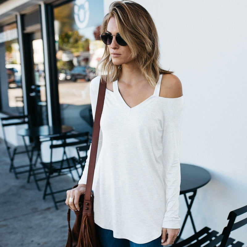 Woman in sun glasses standing with her hands to her side wearing a Cut Loose Long Sleeve Shirt in white