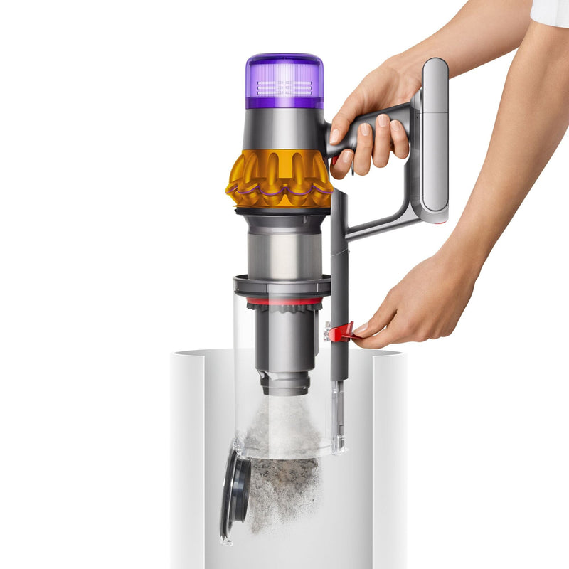 Woman demonstrating how to empty the dirst canister of a Dyson V15 Detect Cordless Stick Vacuum Cleaner