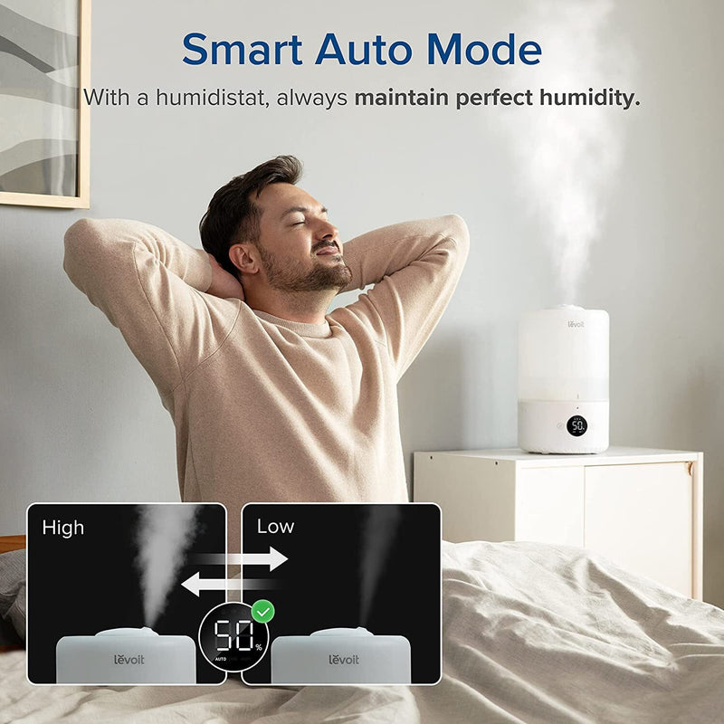 Man getting up from bed with a LEVOIT Dual200S Smart Cool Mist Humidifier active in the background