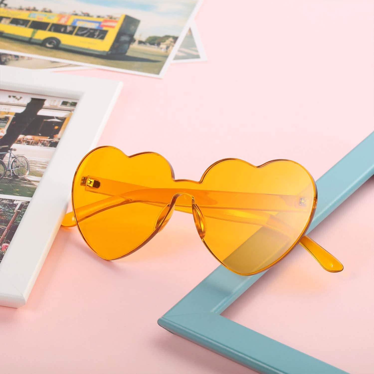 Yellow Maxdot Heart Shape Party Sunglasses folded lying on a table