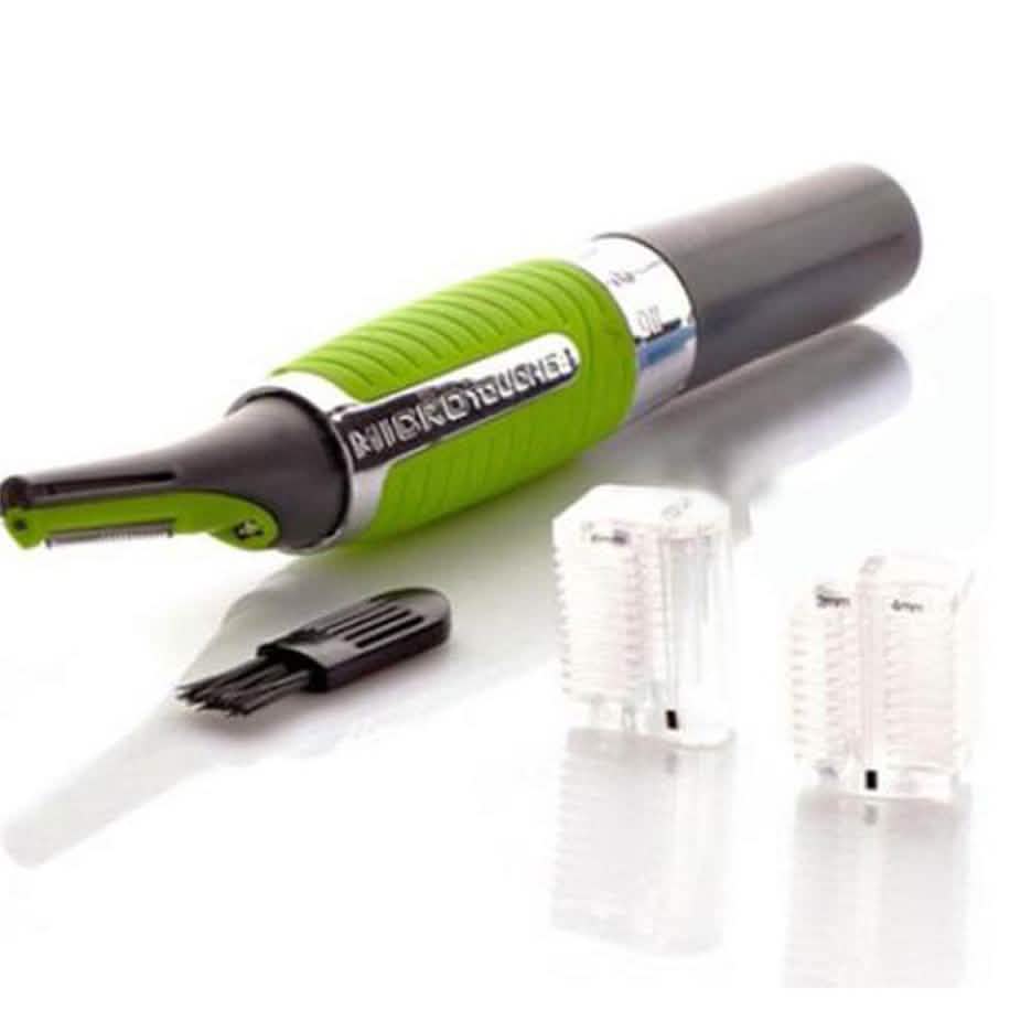 Micro Touch Max - All in one Personal Trimmer with all accessories spread out over a white surface