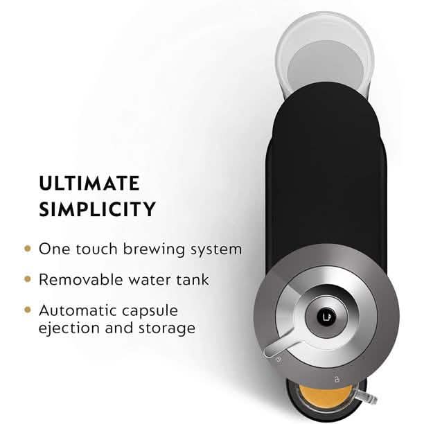 A Nespresso Coffee and Espresso Maker with the water tank removed showcasing the automatic capsule ejection and storage feature