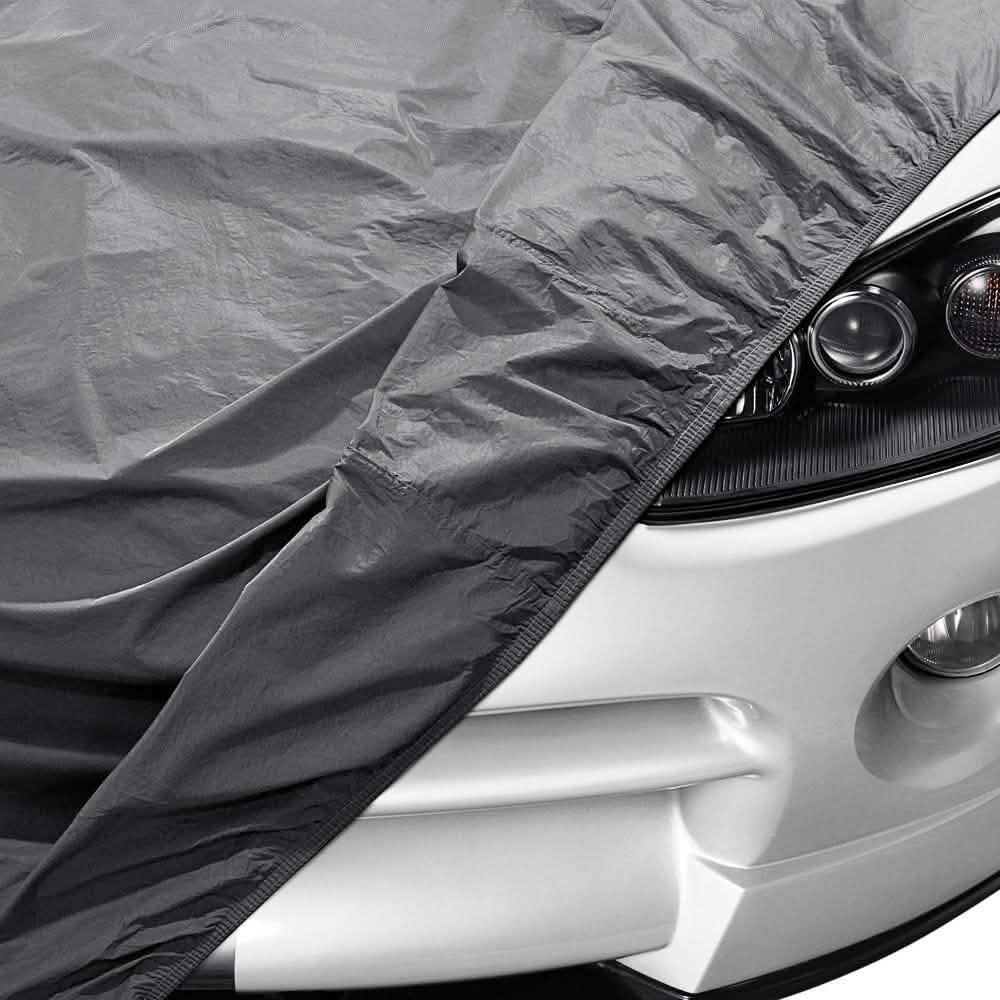 Car's headlamp partially covered with OxGord CCAR-745 Universal Executive Gray Car Cover