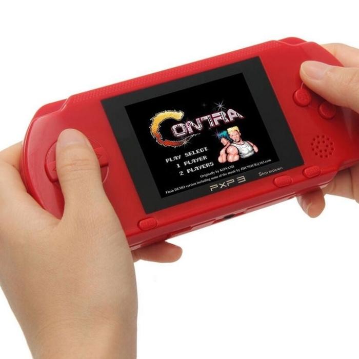 Closeup of two hands holding a PXP3 Portable Handheld Video Game System in red
