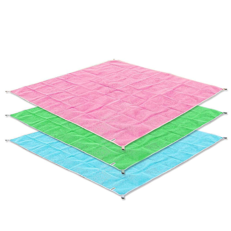 Pink, green, and blue Folded Waterproof Sand Free Beach Mat over a white background