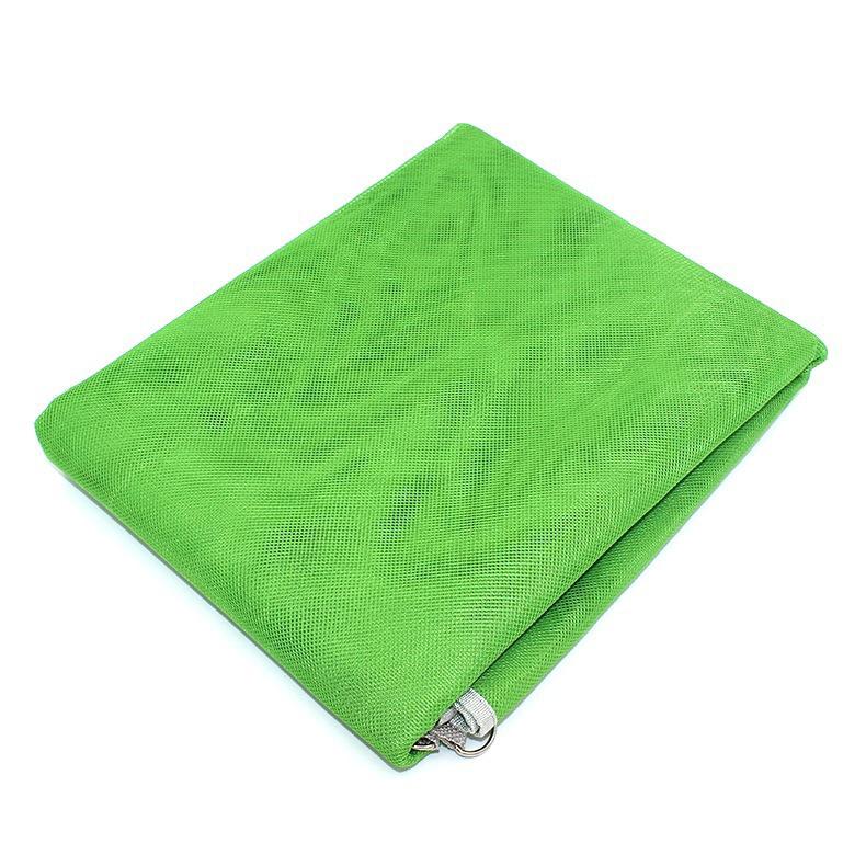 Folded Waterproof Sand Free Beach Mat in green over a white background