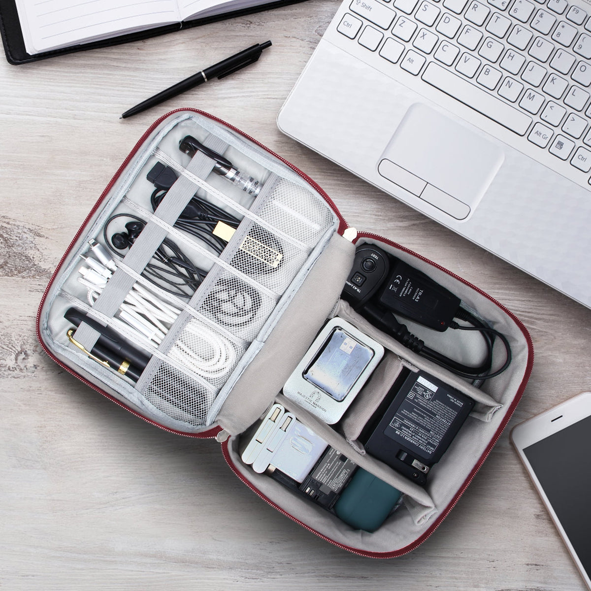 Organizer open on a desk beside a laptop