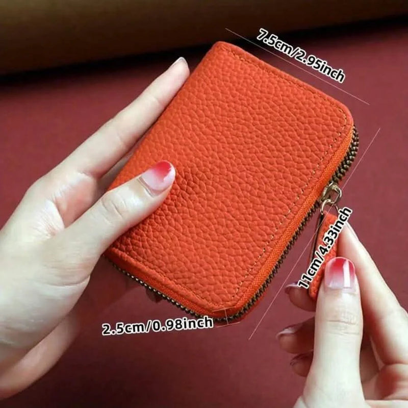 Orange card wallet in hand with dimensions: 11 cm by 7.5 cm by 2.5 cm
