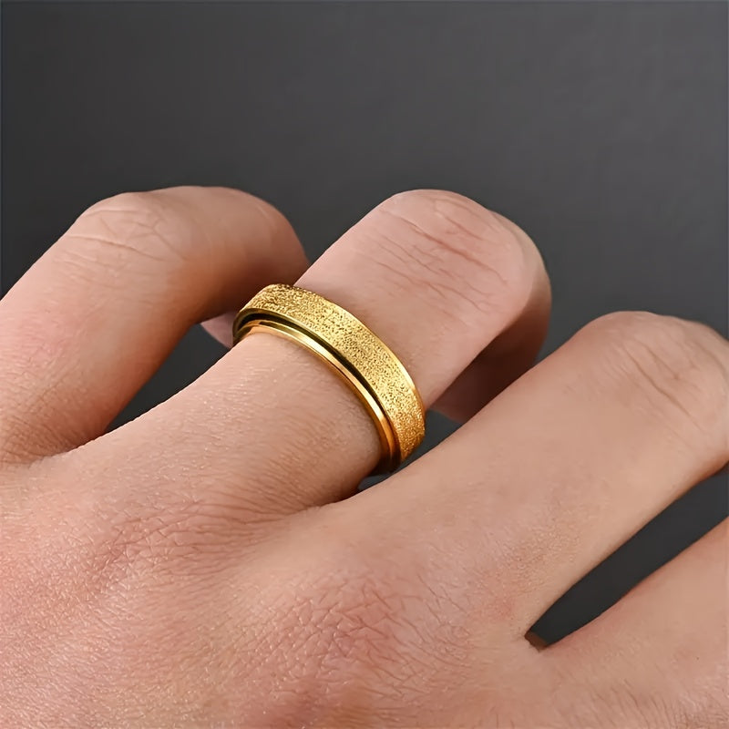 Gold spinner ring worn on a hand