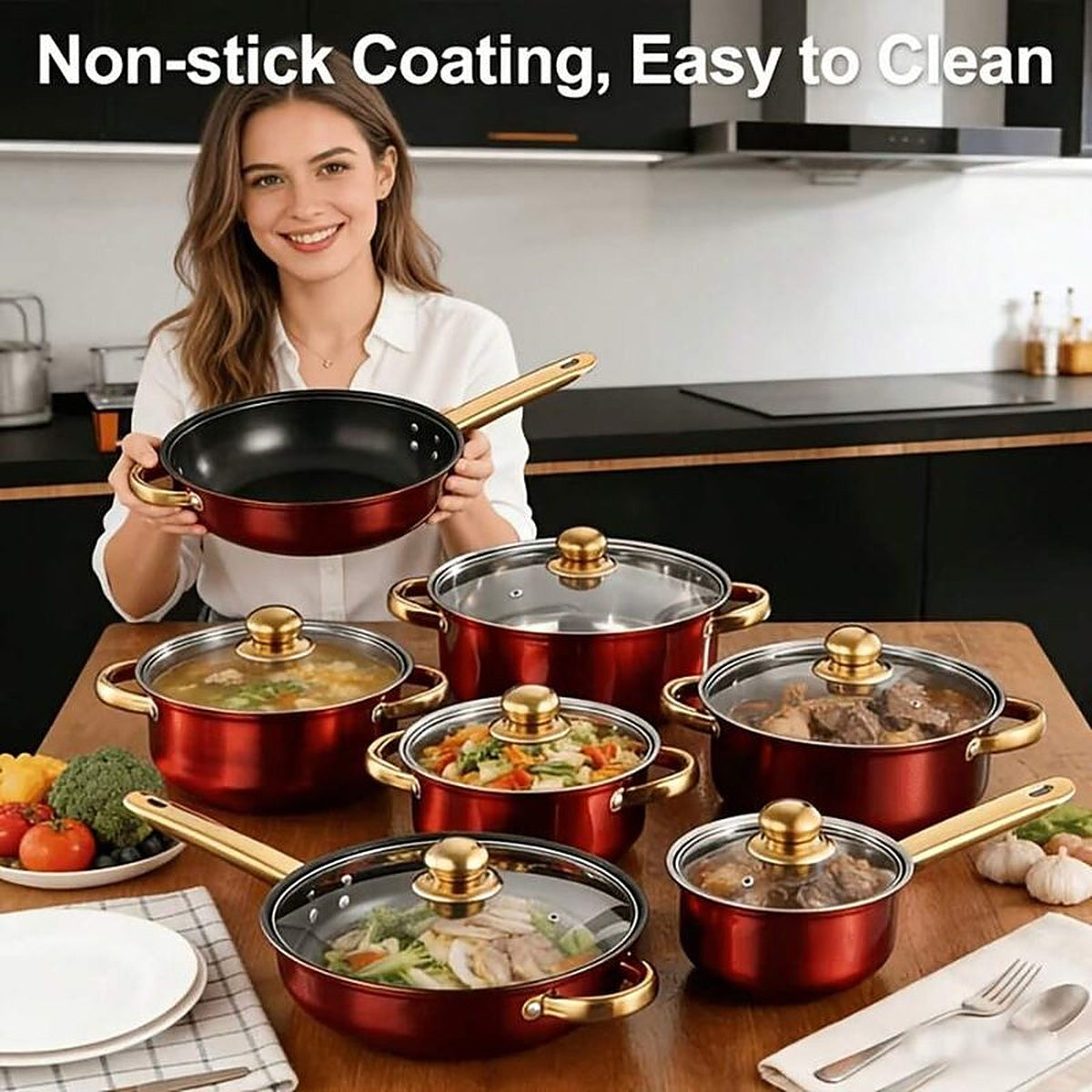 The red set laid out on a kitchen table with food in the pots, and the non-stick black interior of the frying pan held up