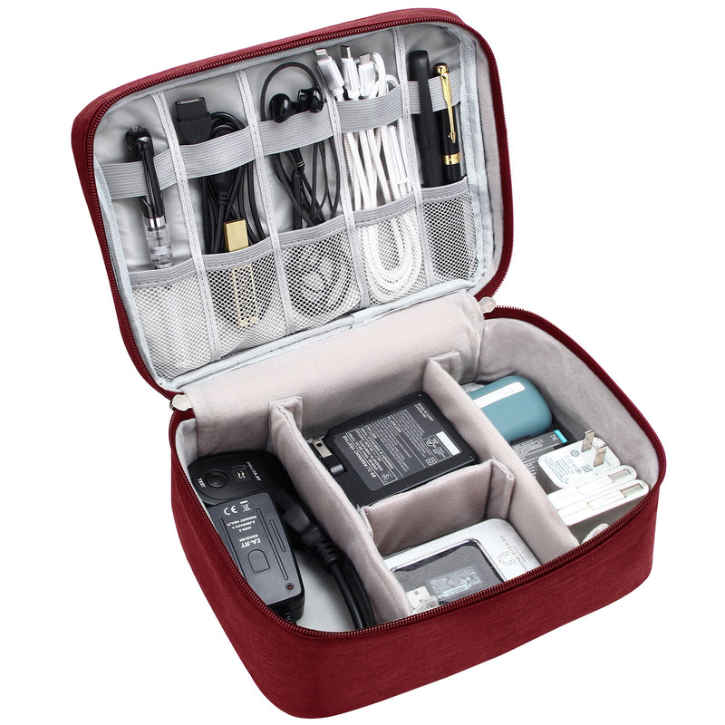 Red travel electronics organizer open and packed with cables and accessories