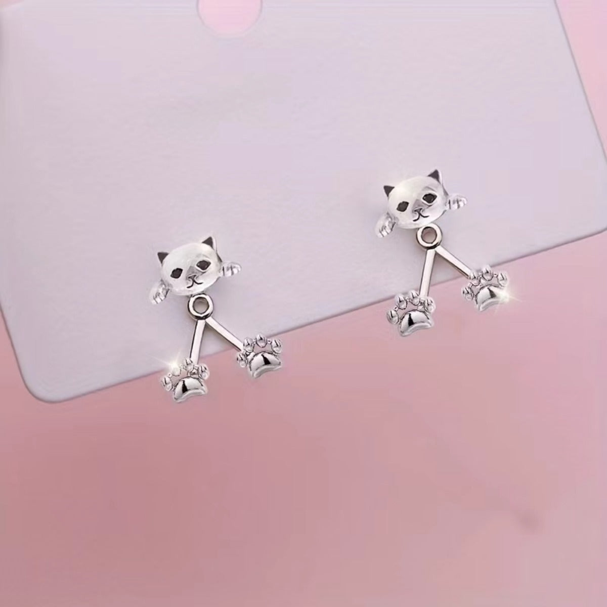 The pair laid on a pale pink card, showing the kitten front piece and the two-paw back piece