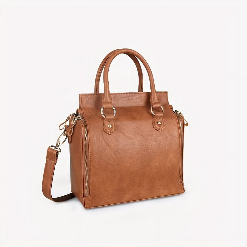 The bag on a plain background with the crossbody strap clipped on and hanging loose