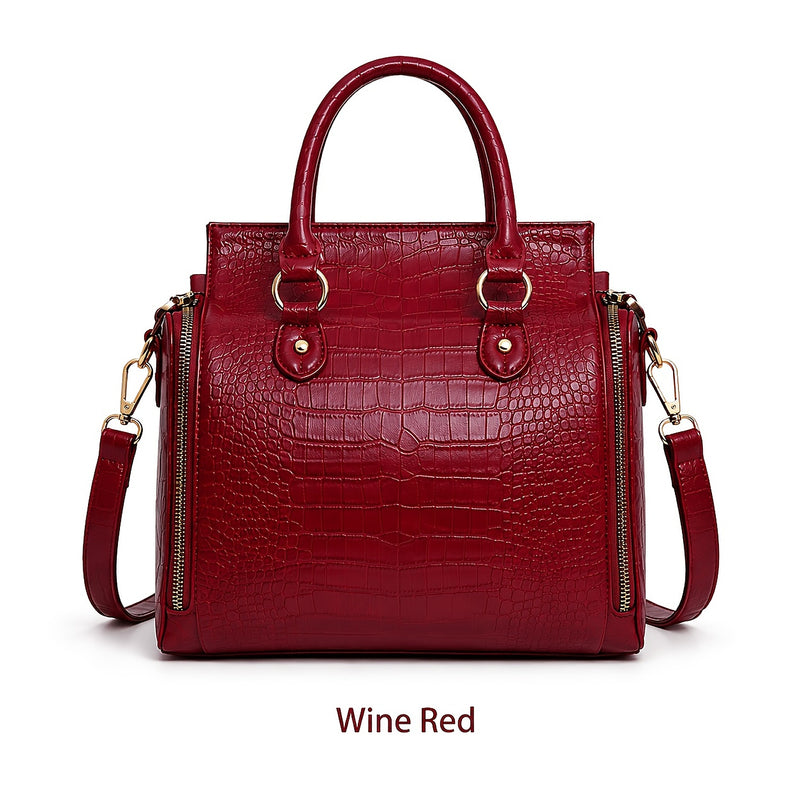 The bag in Wine Red, front view with the crossbody strap attached