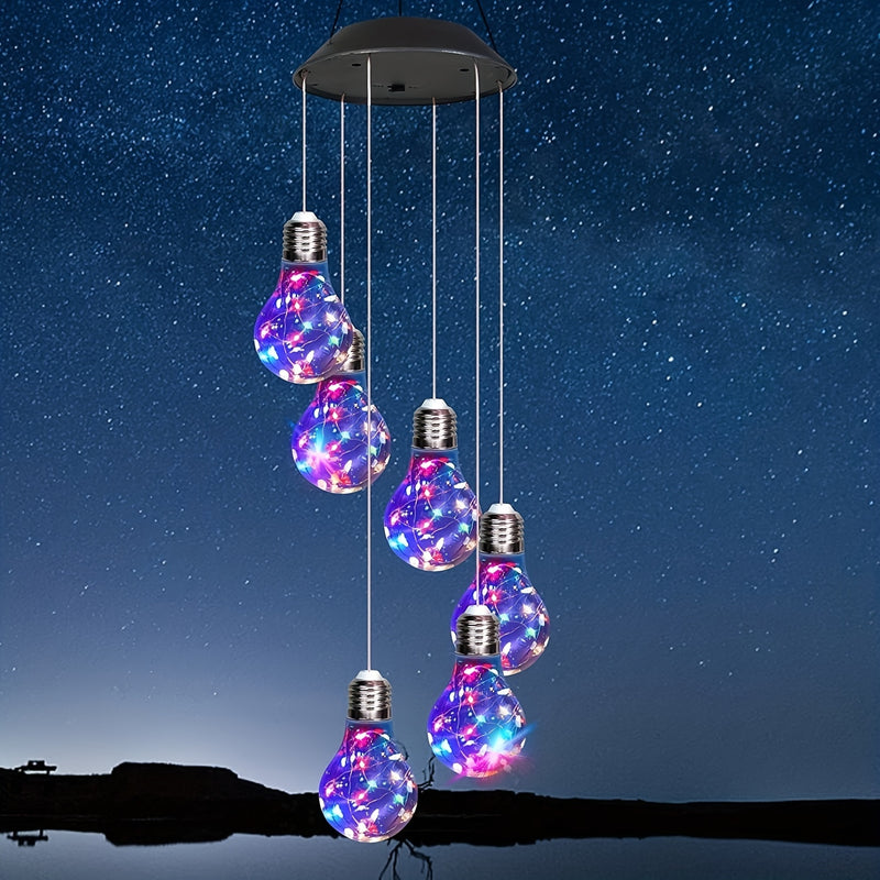 Six bulb-shaped globes hanging from a black solar cap, lit in pink, blue and green against a night sky